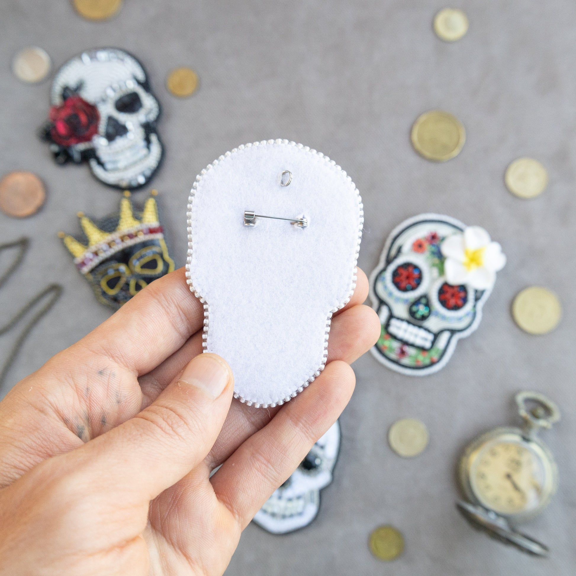 a person holding a white piece of paper with a skull on it