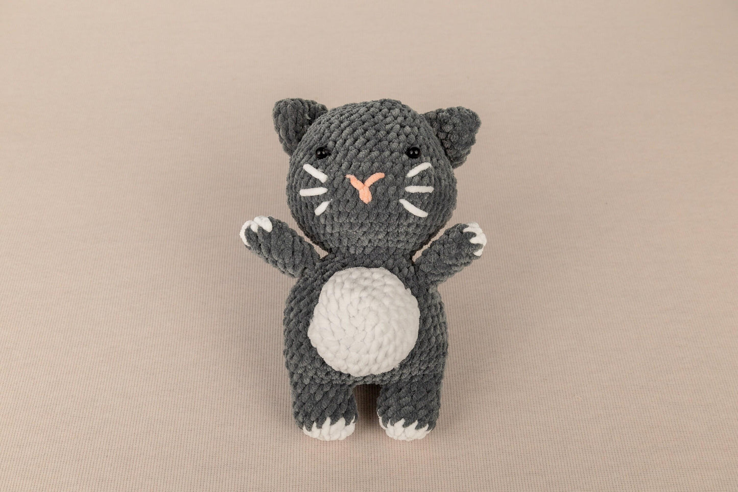 a crocheted black and white kitty cat