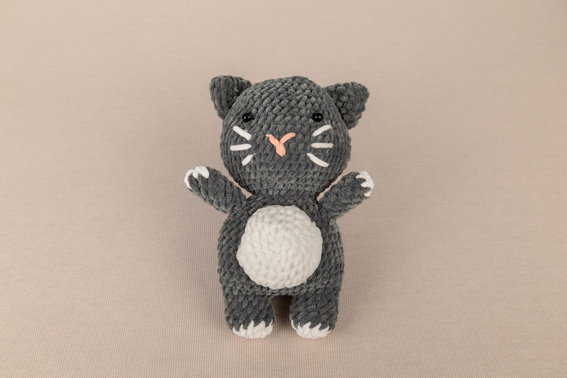 a crocheted black and white kitty cat