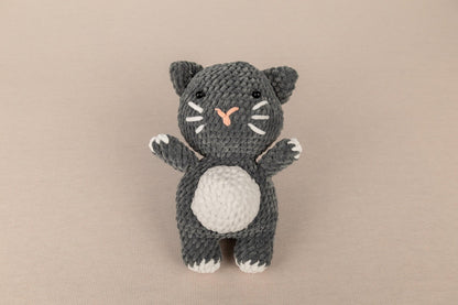 a crocheted black and white kitty cat