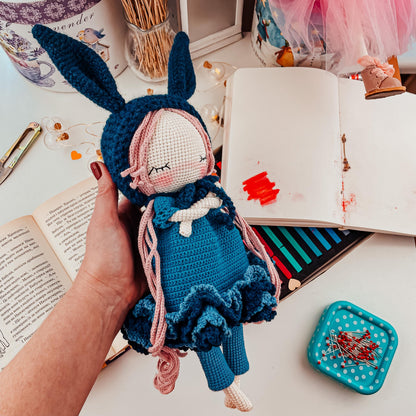 a person is holding a doll in front of a book