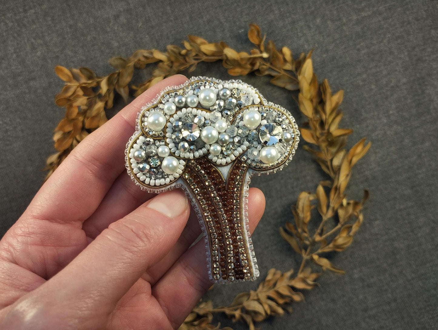 a person holding a brooch in their hand