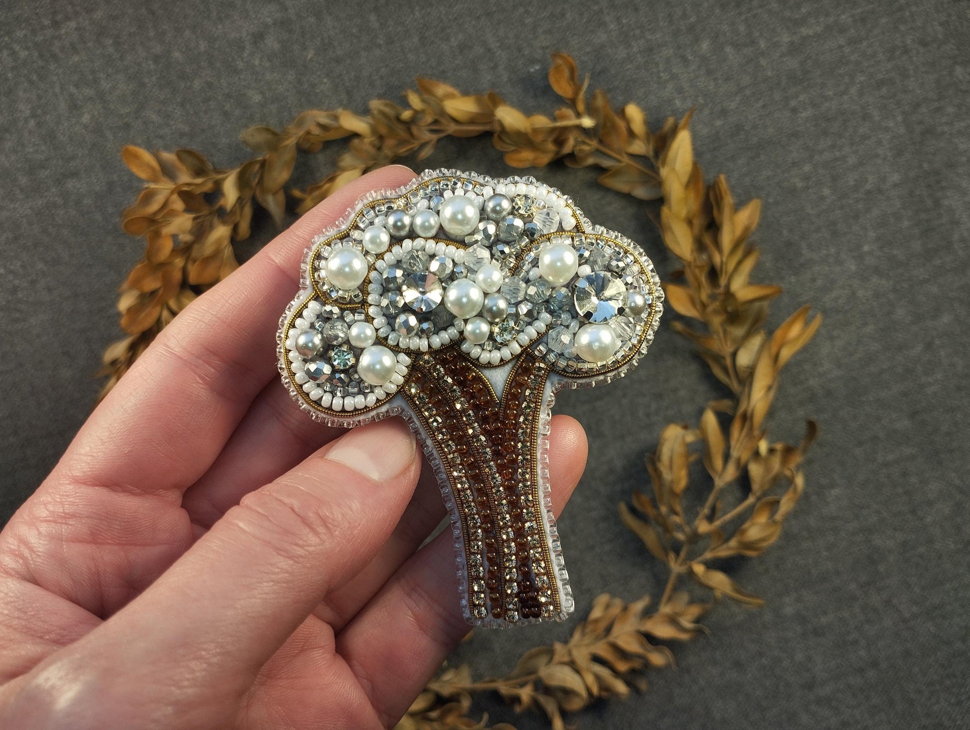 a person holding a brooch in their hand