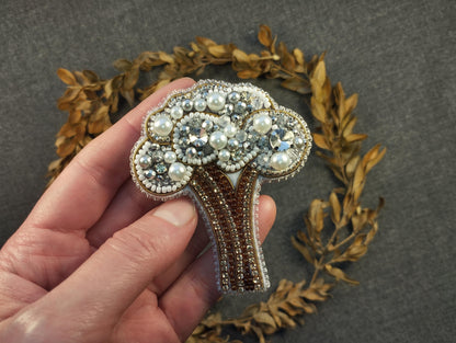 a person holding a brooch in their hand