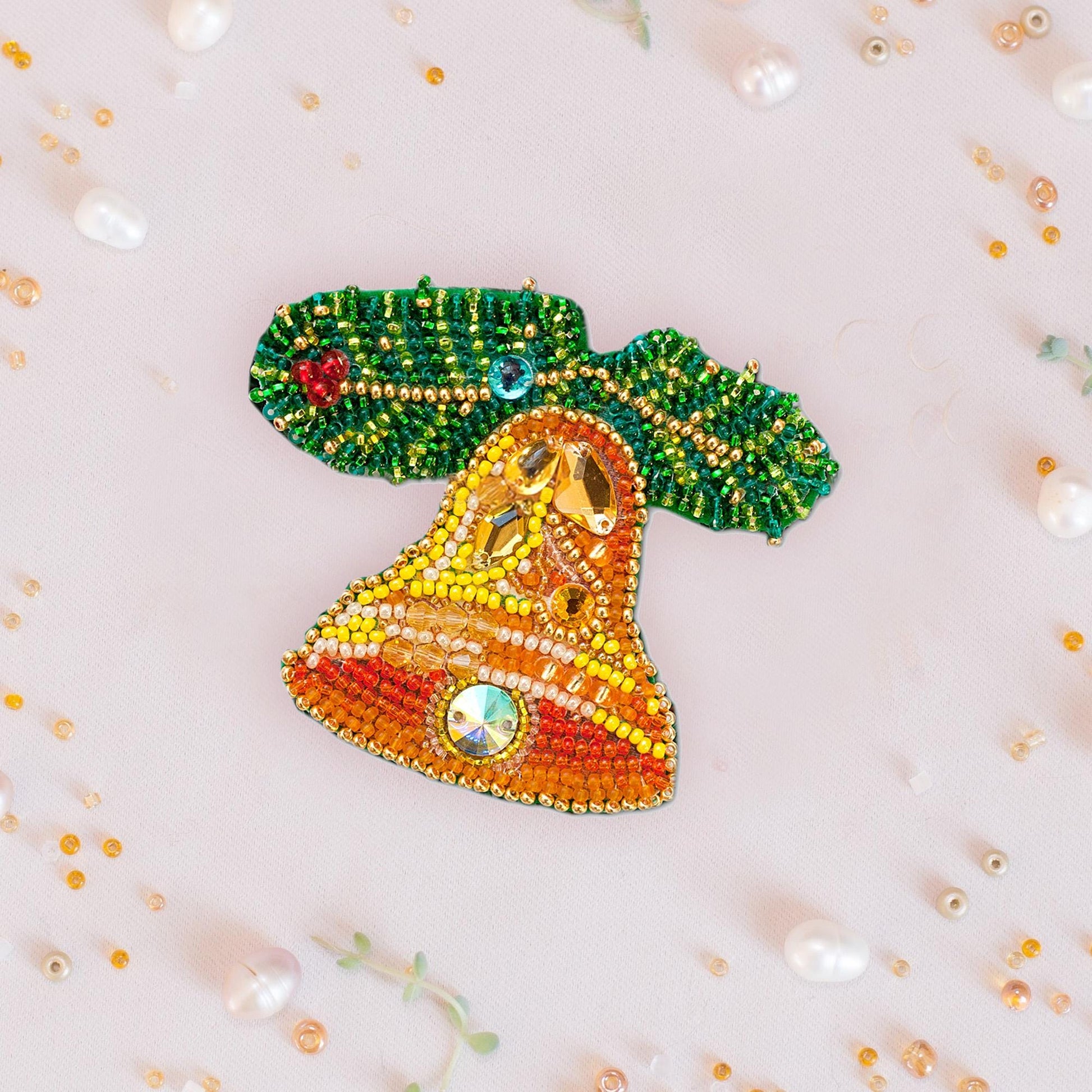 a beaded christmas ornament on a white surface