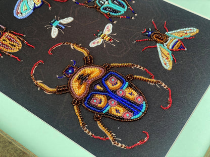 a close-up view of a detailed beaded artwork depicting a large, colorful beetle with intricate patterns and designs.