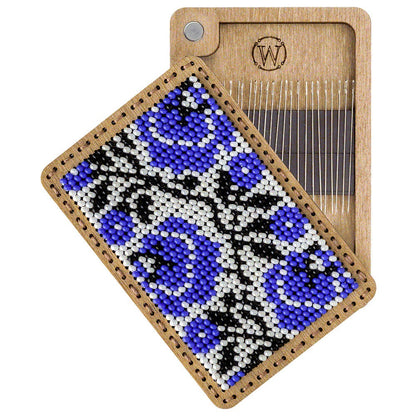 a piece of beaded art on a wooden board