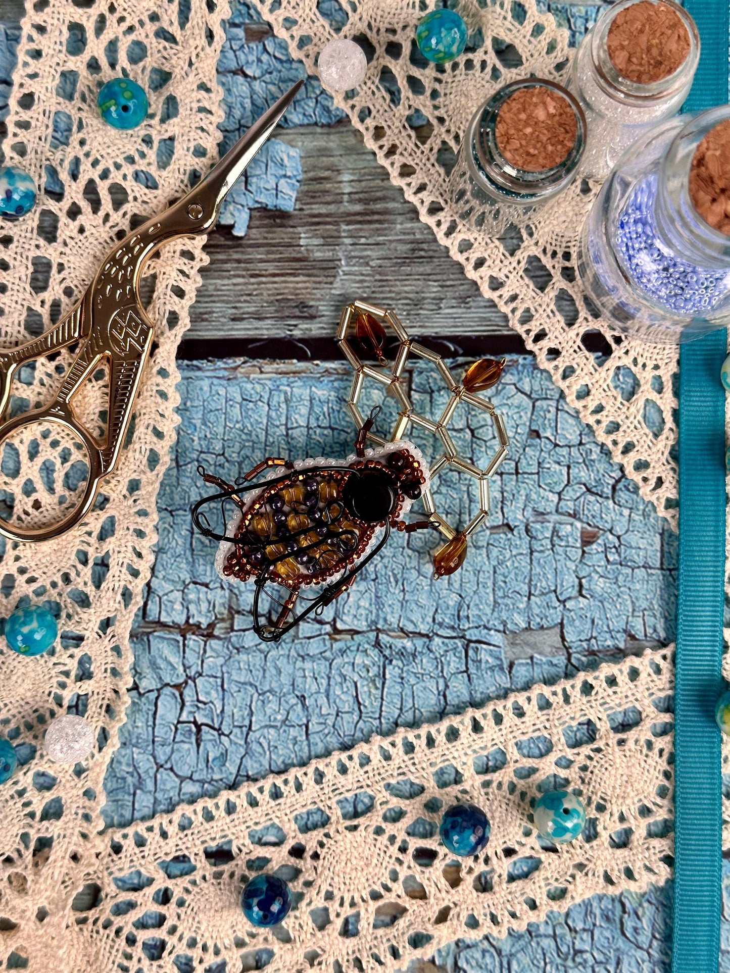a pair of scissors and some beads on a table