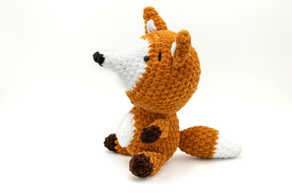 a crocheted stuffed animal sitting on a white surface