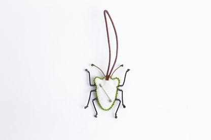 a bug ornament hanging from a cord
