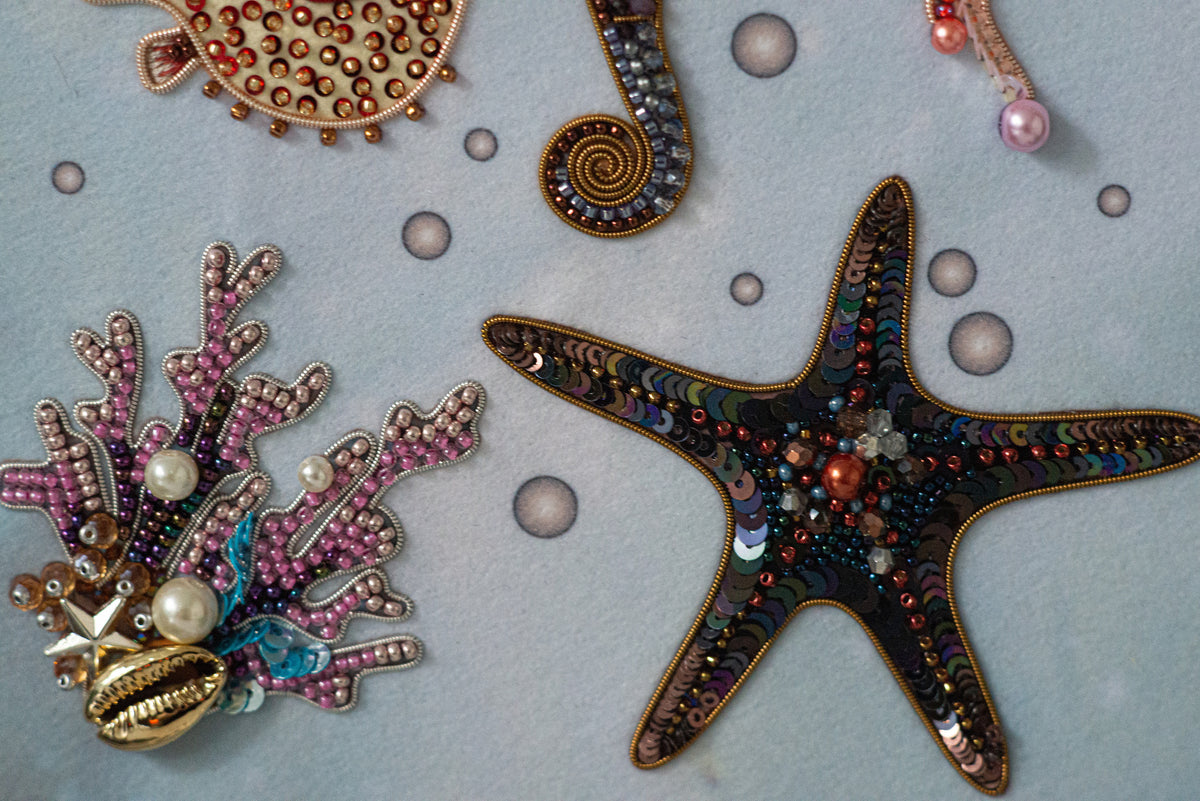 a close-up view of a collection of colorful, intricately designed sea-themed objects, including a starfish, a coral, and various other marine elements.