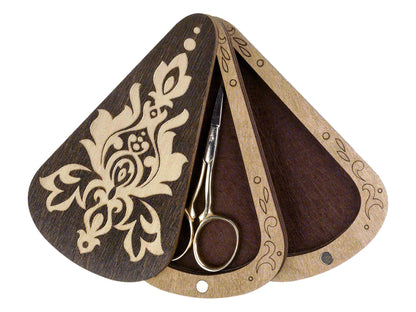 a pair of scissors sitting on top of a wooden holder