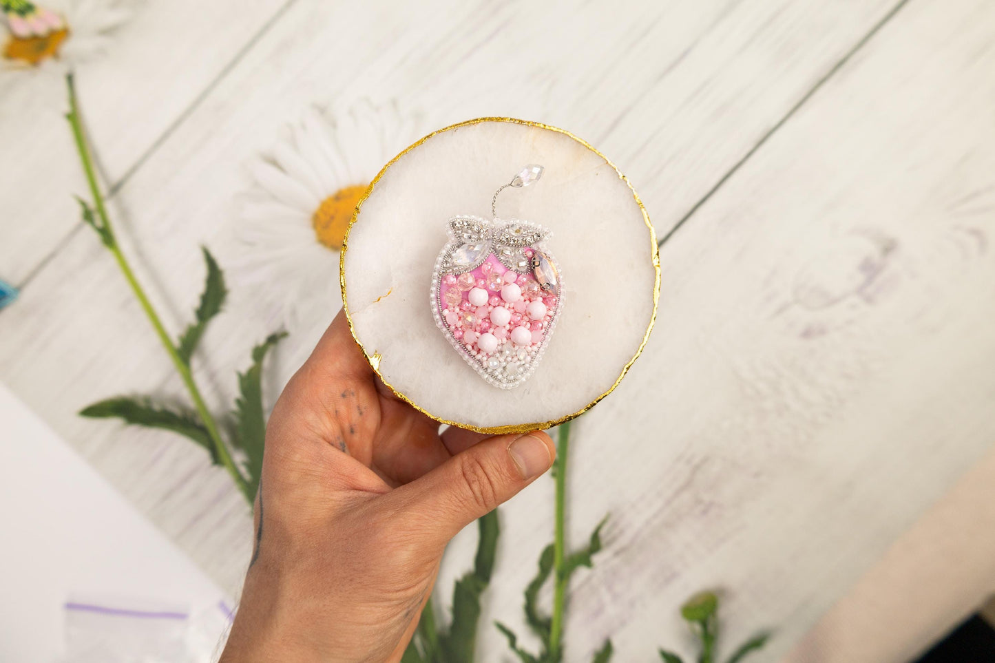 a person holding a cupcake with a heart on it