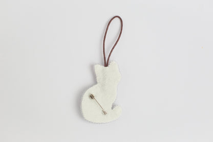 a white ornament hanging from a brown cord