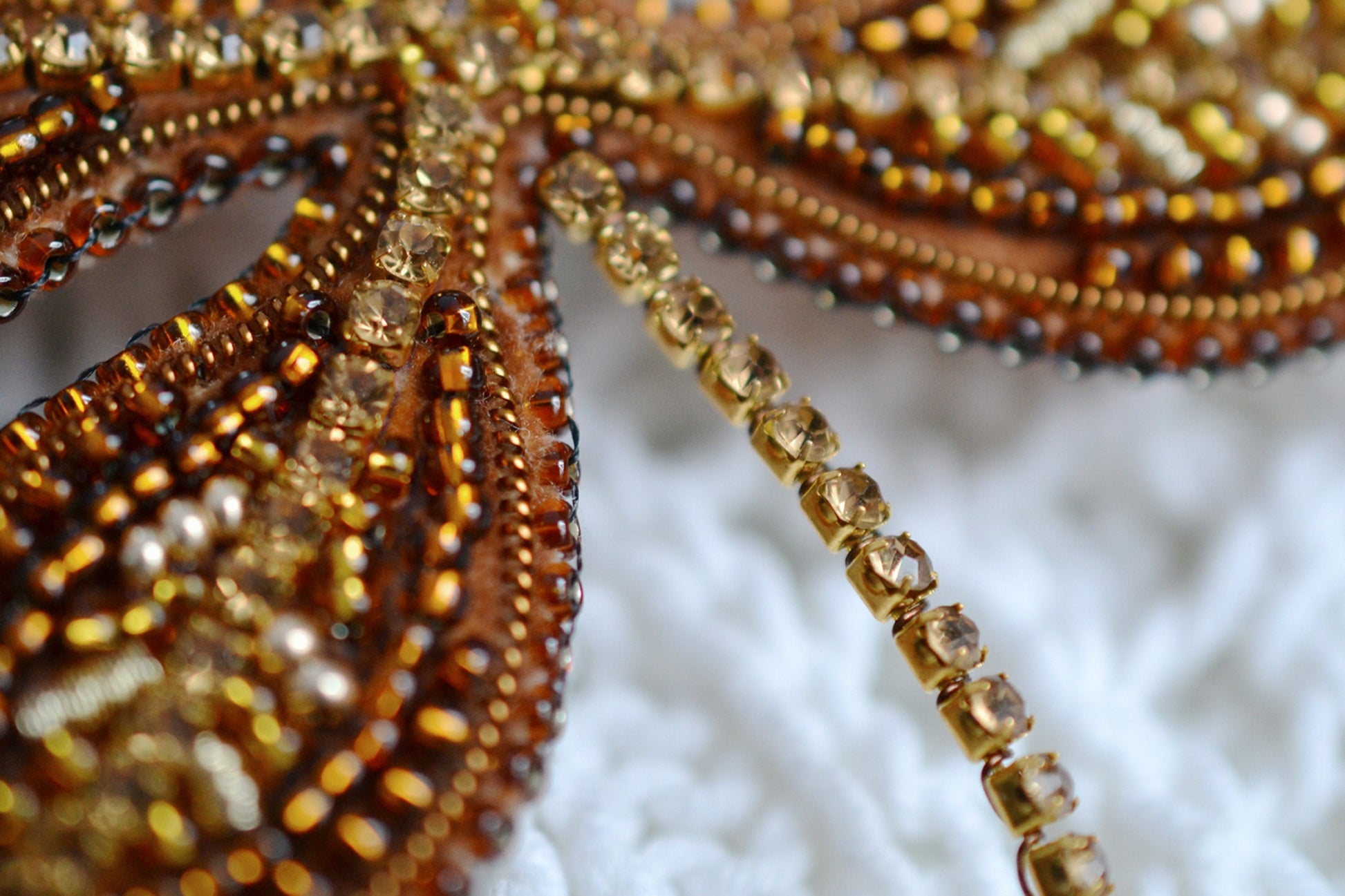 a close up of beads on a white surface