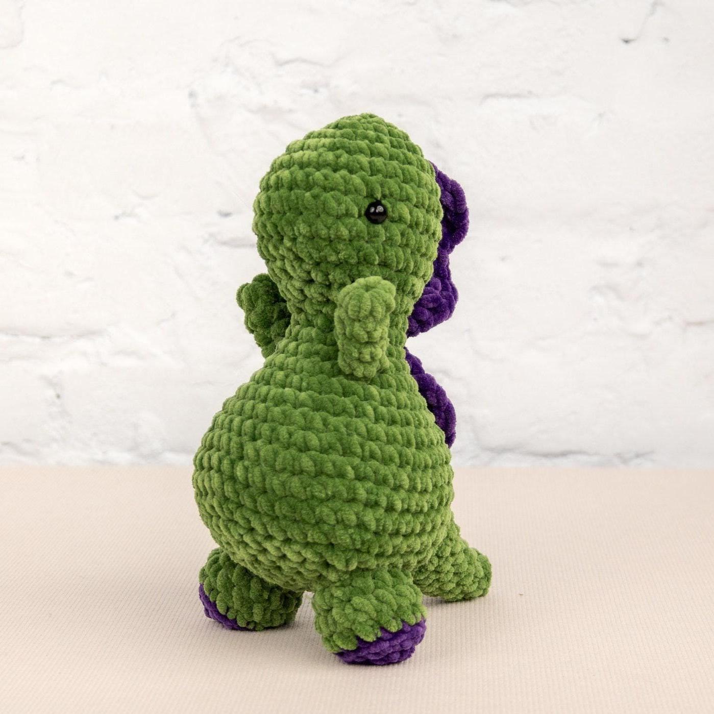 a crocheted green and purple stuffed animal