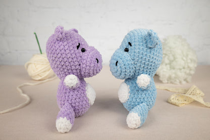 two crocheted stuffed animals sitting next to each other
