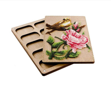 two coasters with a bird and a flower on them
