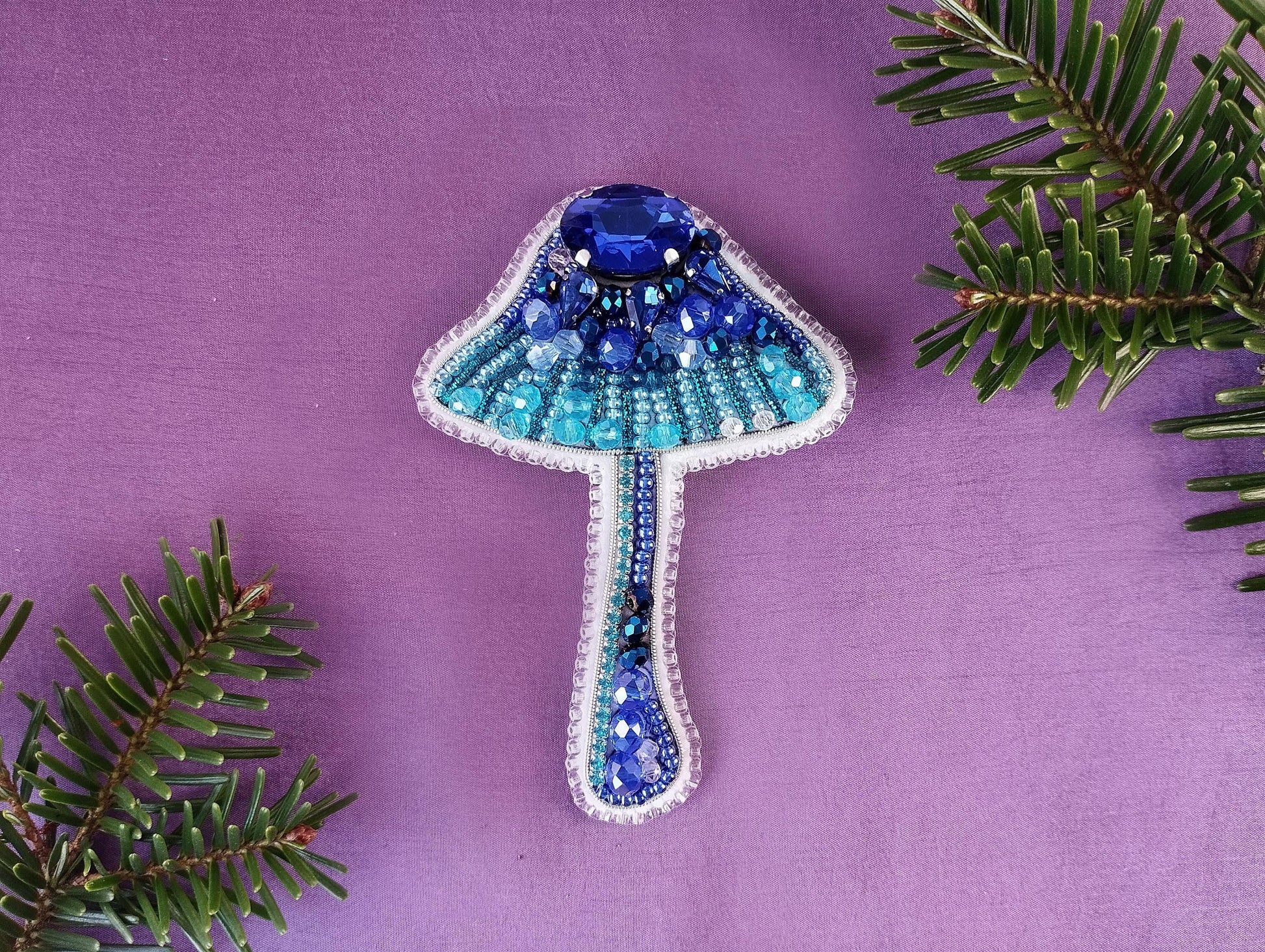 a blue and white lamp hanging from a tree