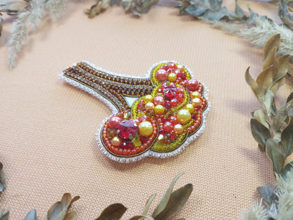 a close up of a brooch on a table