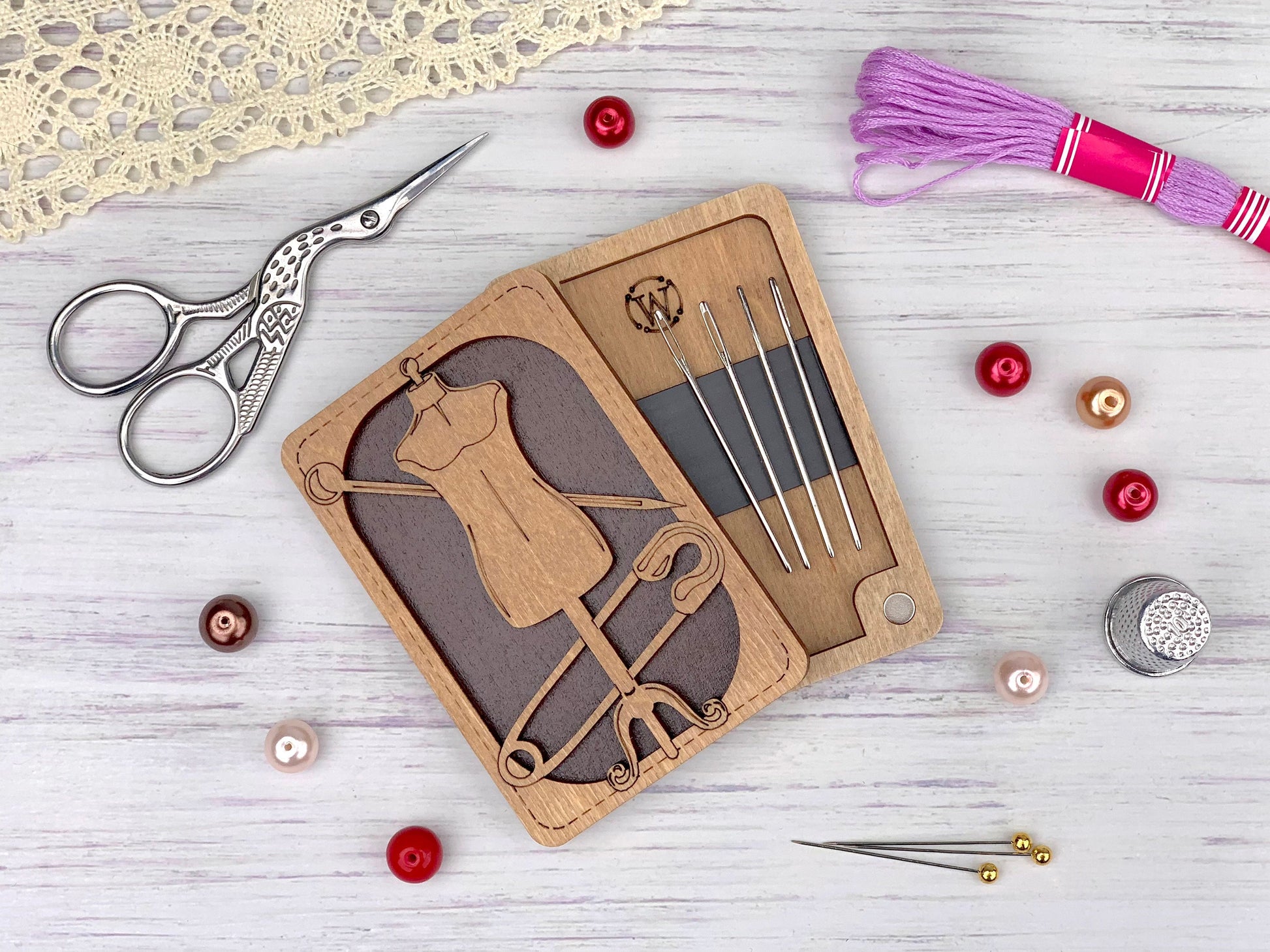 a wooden cutout of a sewing machine and a pair of scissors