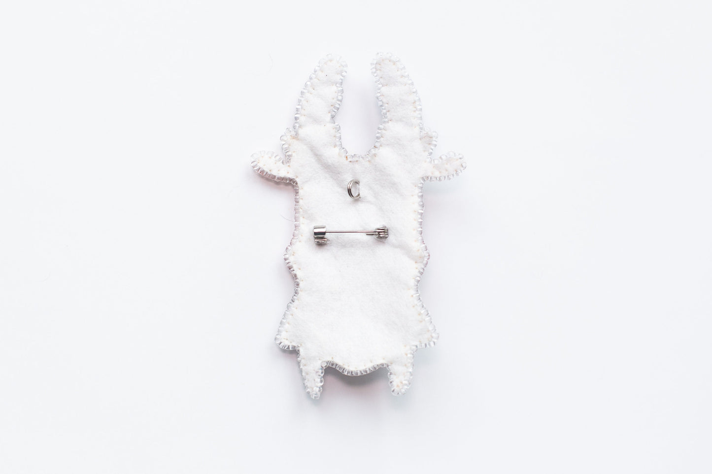 a white piece of cloth with a pin on it