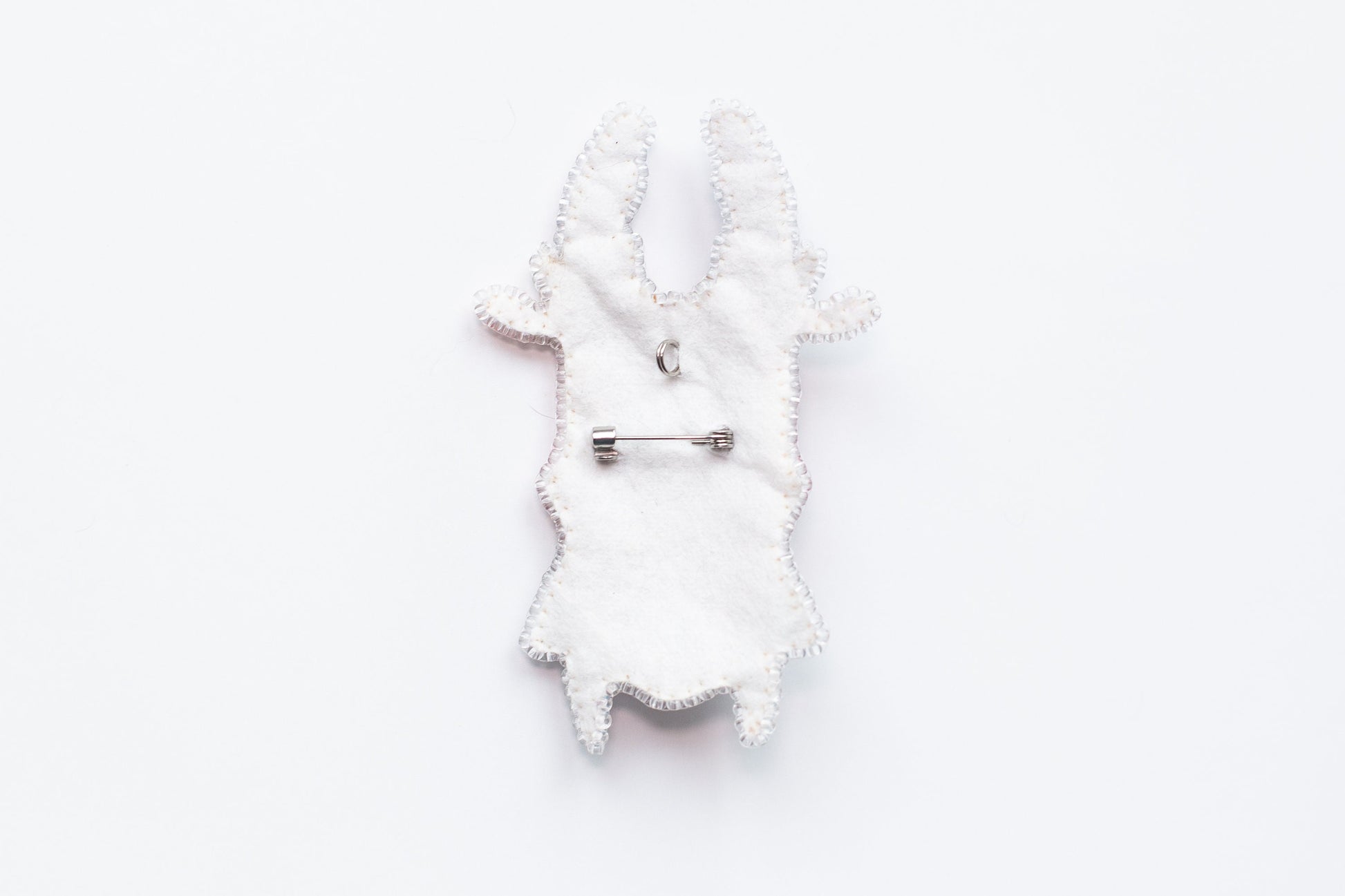 a white piece of cloth with a pin on it