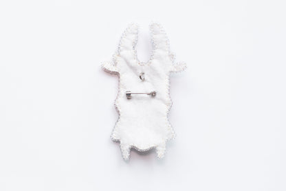 a white piece of cloth with a pin on it