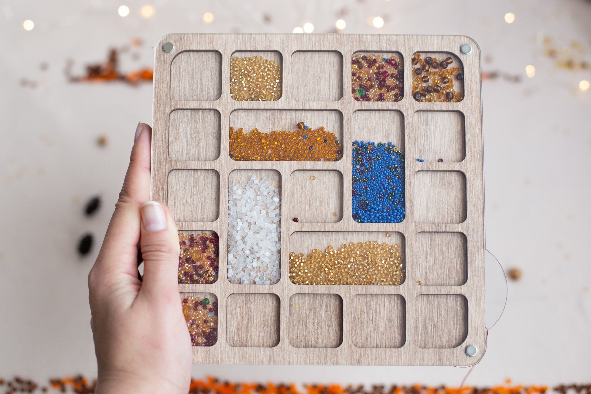 a person holding a wooden tray with different types of food in it