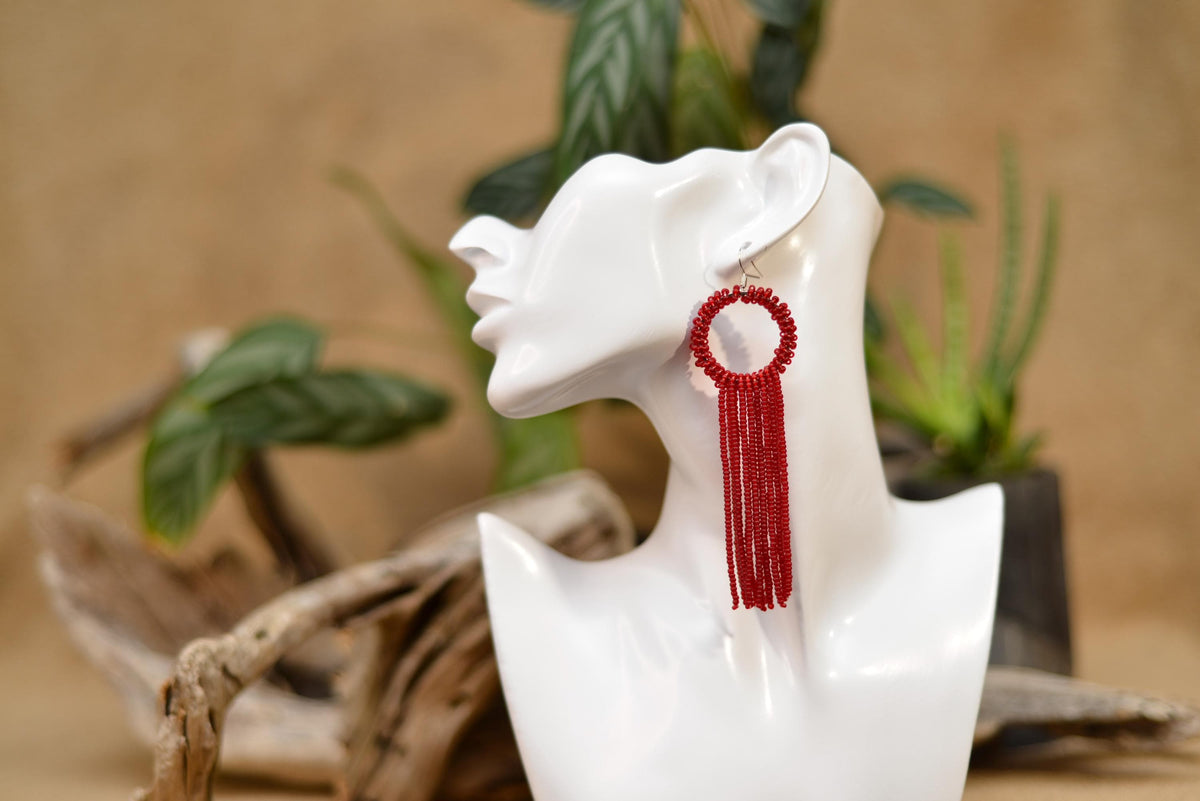 a white mannequin with a red tassel on it