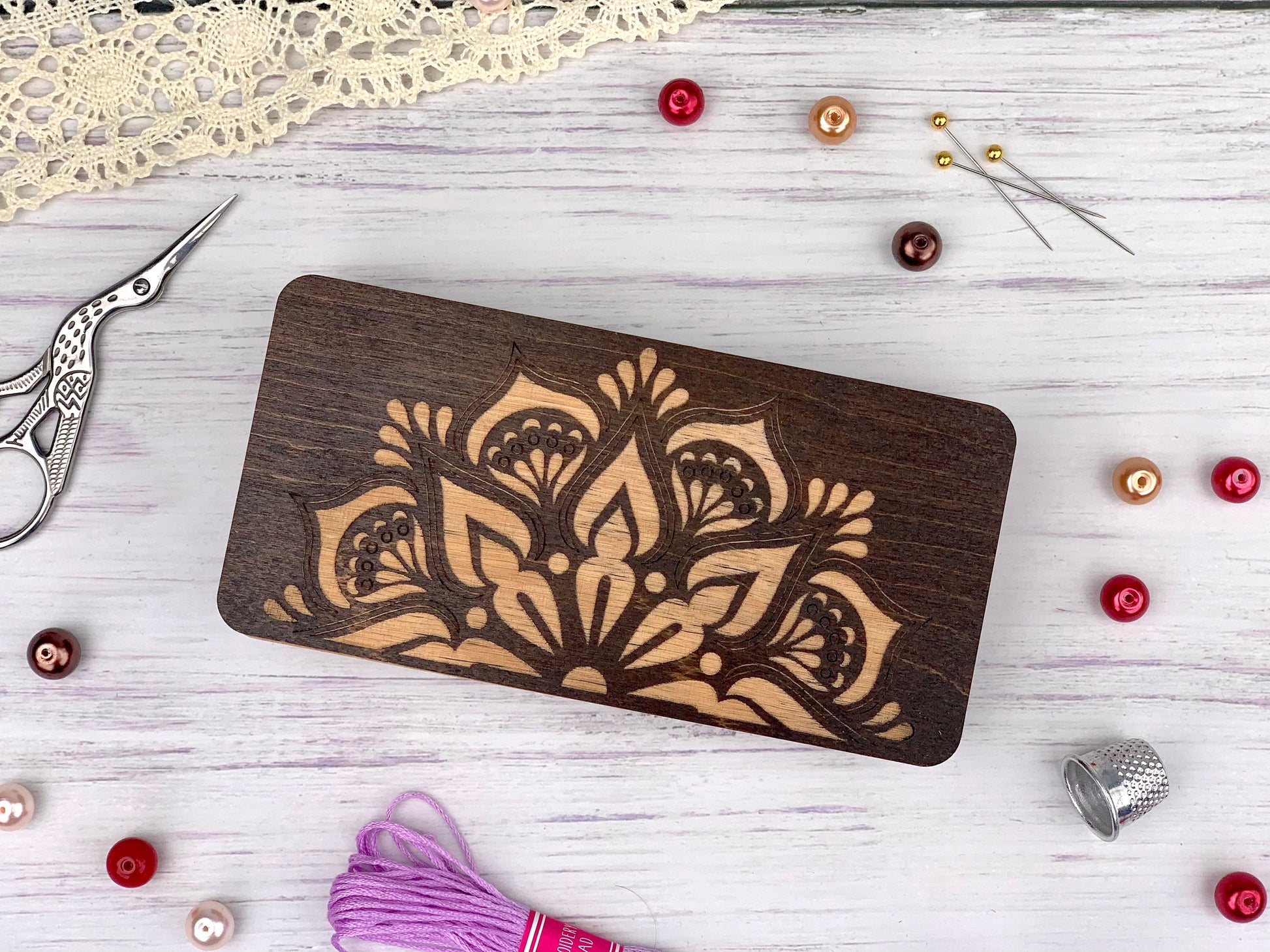 a wooden cutting board sitting on top of a table next to a pair of scissors