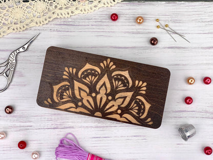 a wooden cutting board sitting on top of a table next to a pair of scissors
