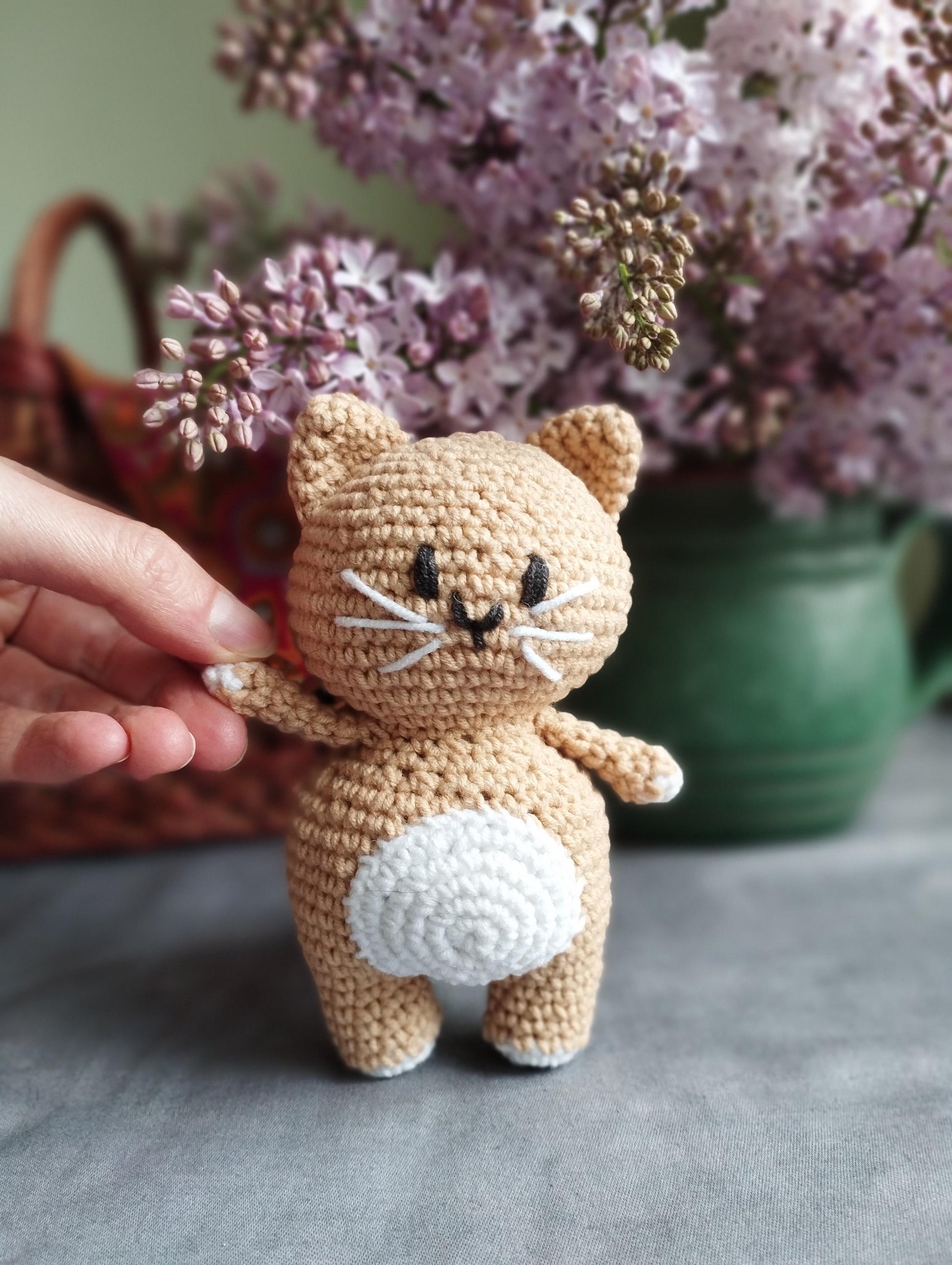 a small crocheted cat sitting on top of a table