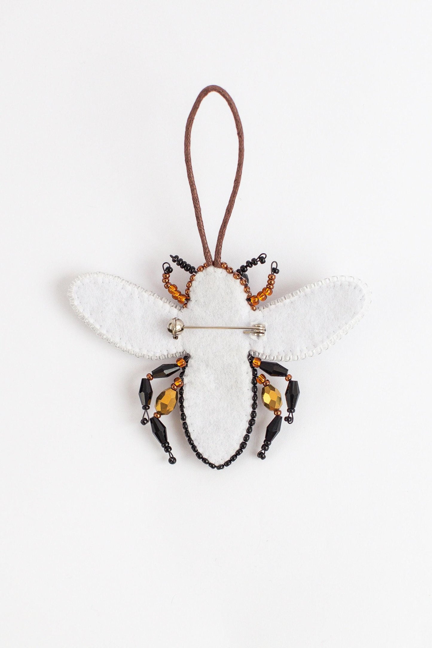 a bee ornament hanging from a cord