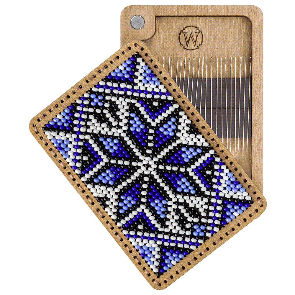 a wooden comb with a blue and white design on it