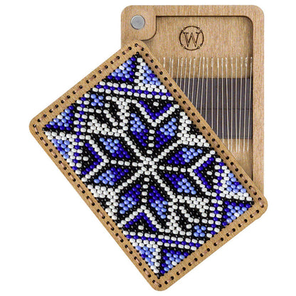 a wooden comb with a blue and white design on it