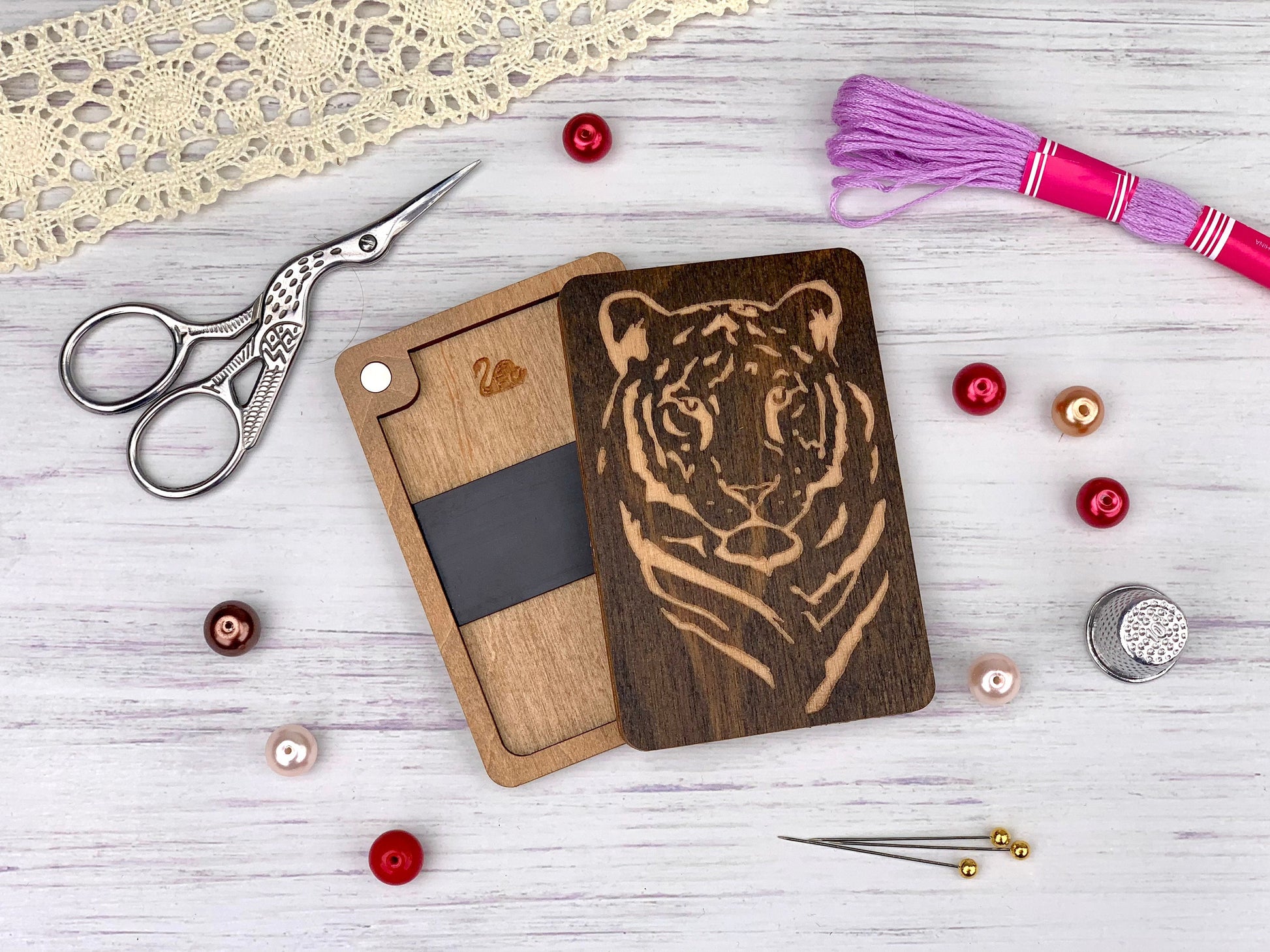 a cutting board with a tiger on it next to a pair of scissors