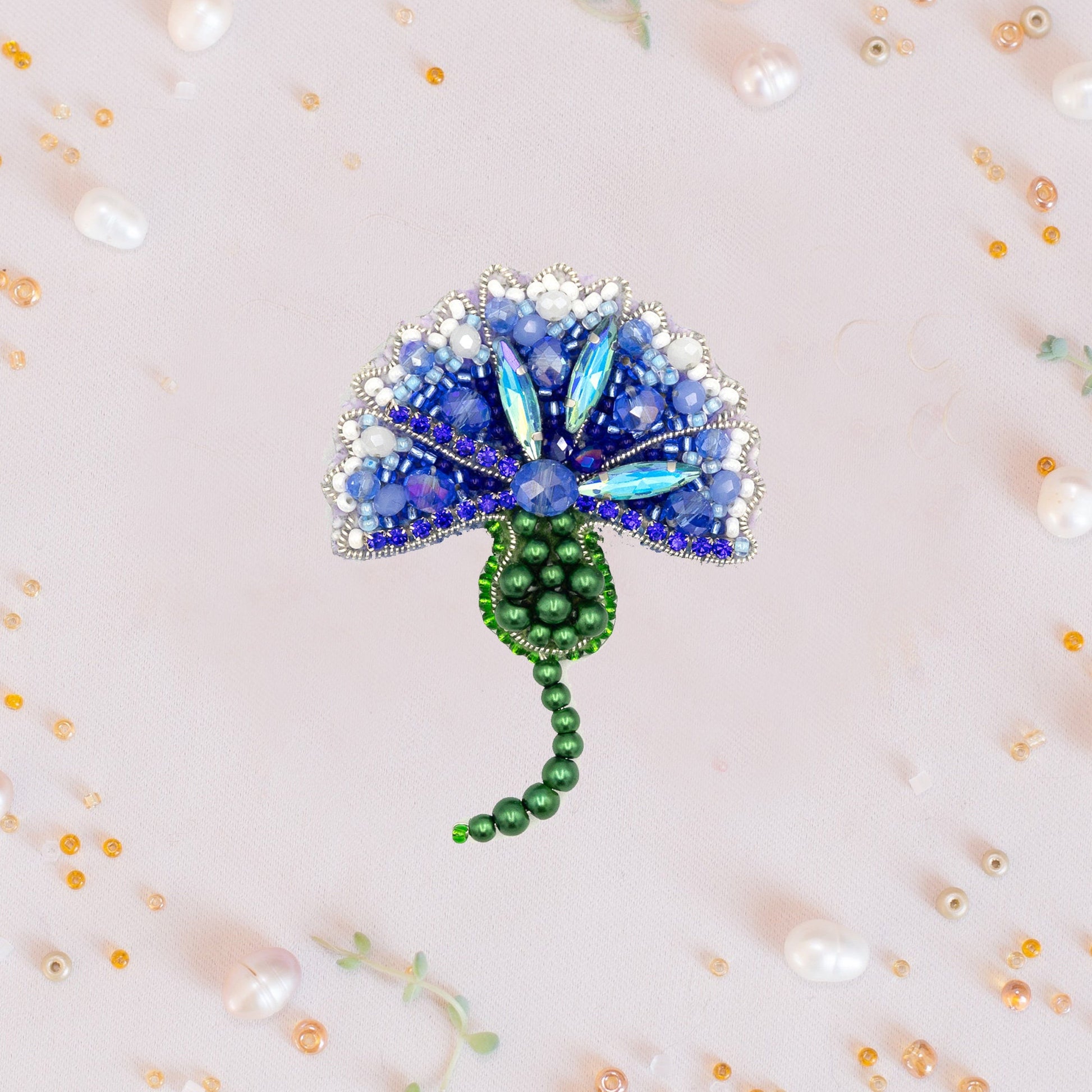 a brooch with a blue flower on it