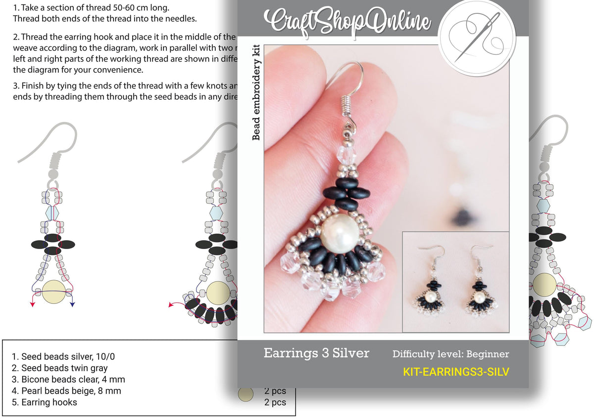 a picture of a hand holding a pair of earrings