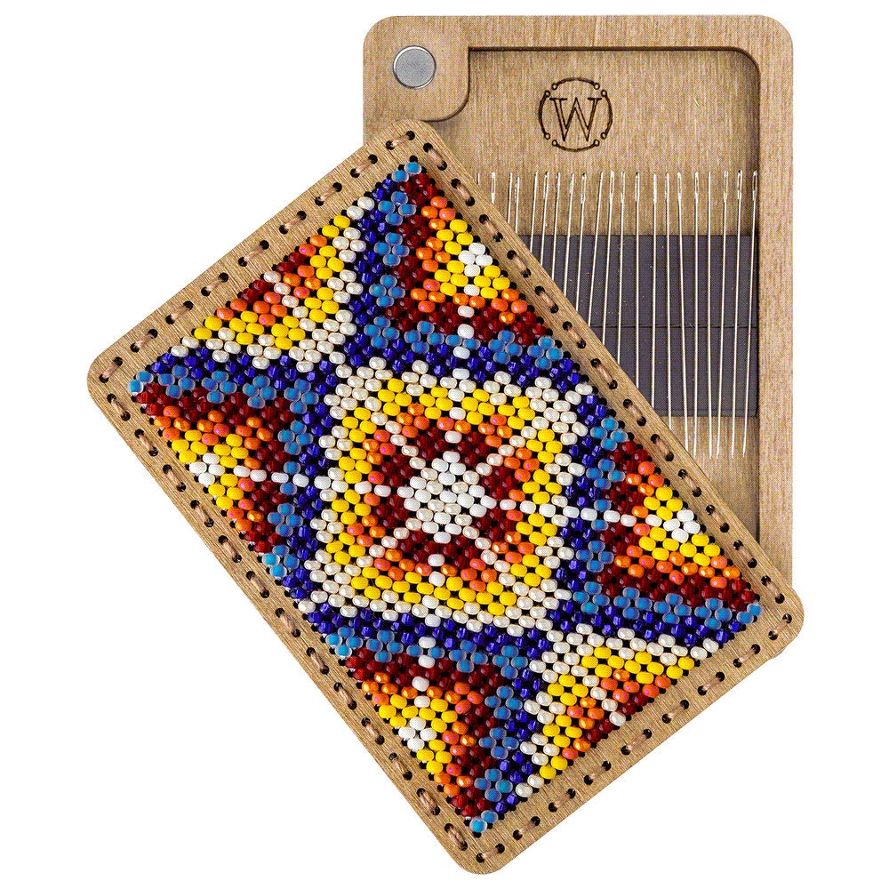 a piece of wood with a beaded design on it