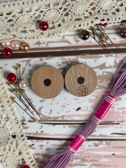 a pair of wooden buttons sitting on top of a table
