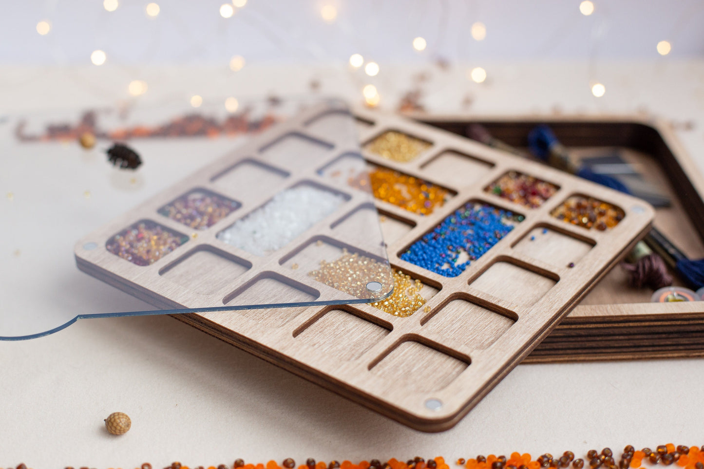 a wooden tray with a variety of beads in it