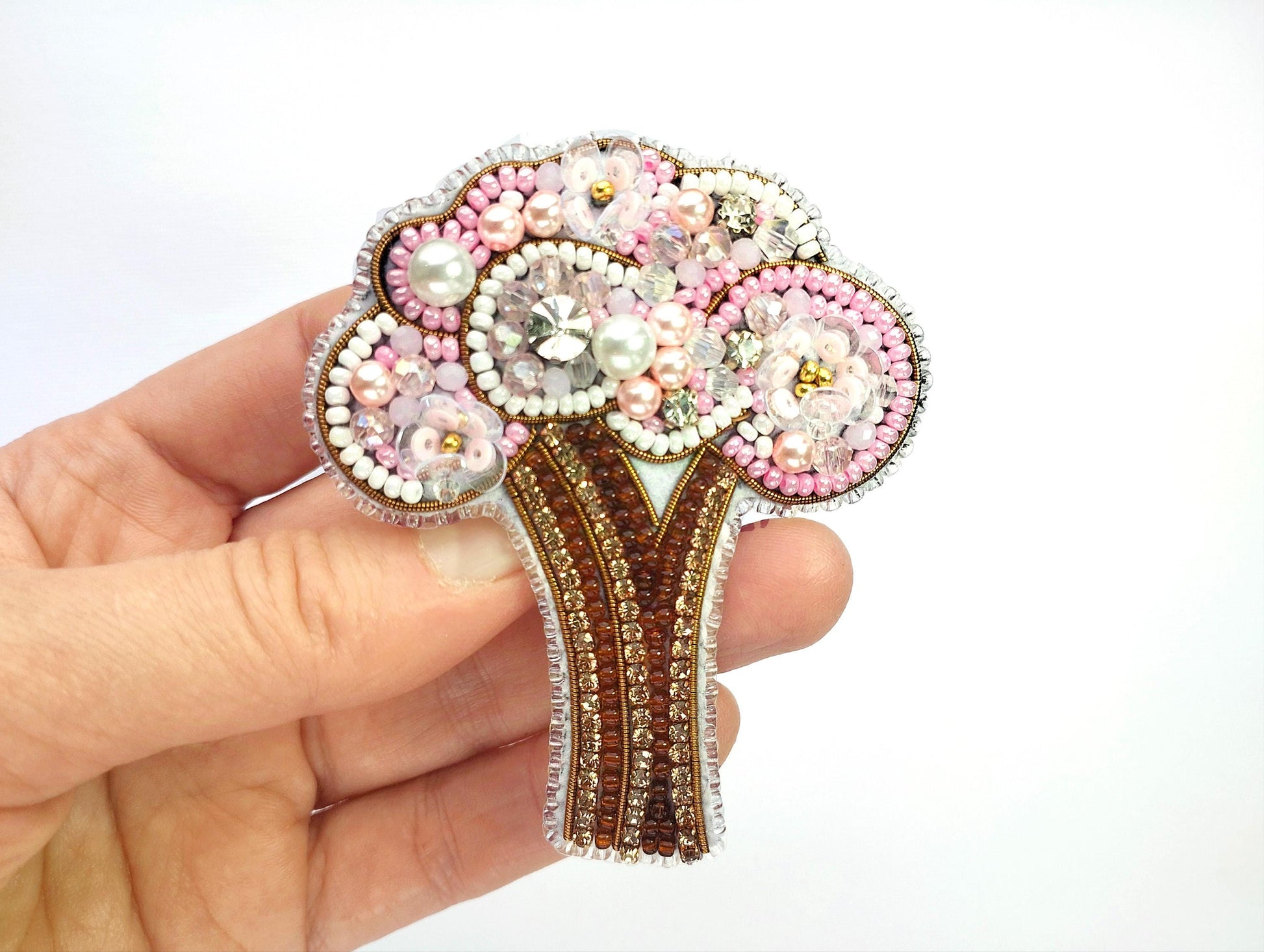 a person holding a brooch in their hand