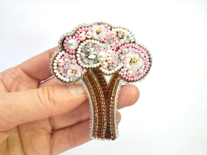 a person holding a brooch in their hand