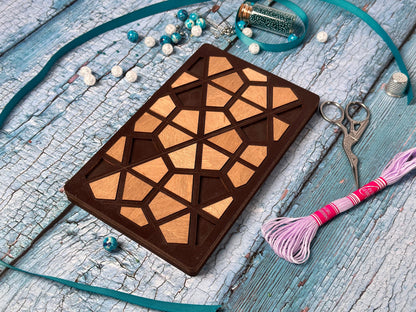 a wooden case sitting on top of a table next to a pair of scissors