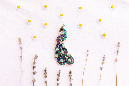 a picture of a brooch sitting on top of a table