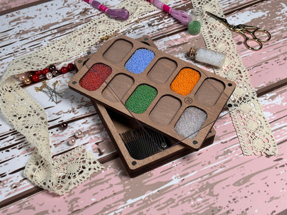 a wooden box filled with lots of different colored beads