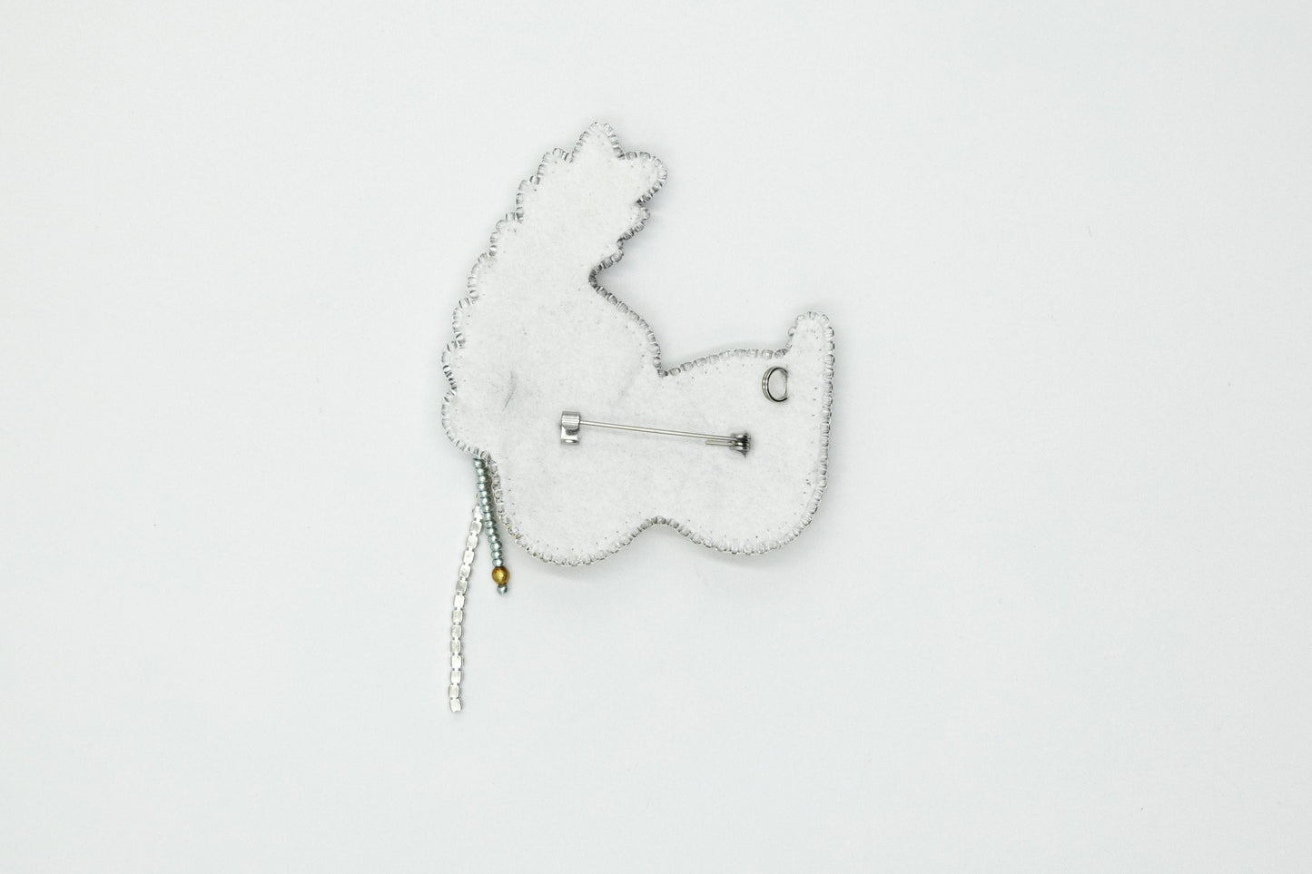 a white brooch with a white bear on it
