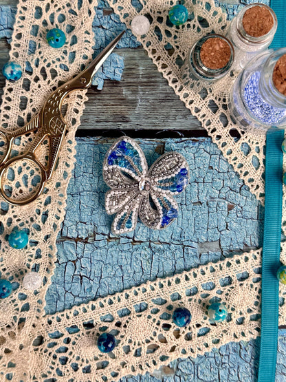 a pair of scissors sitting on top of a piece of lace