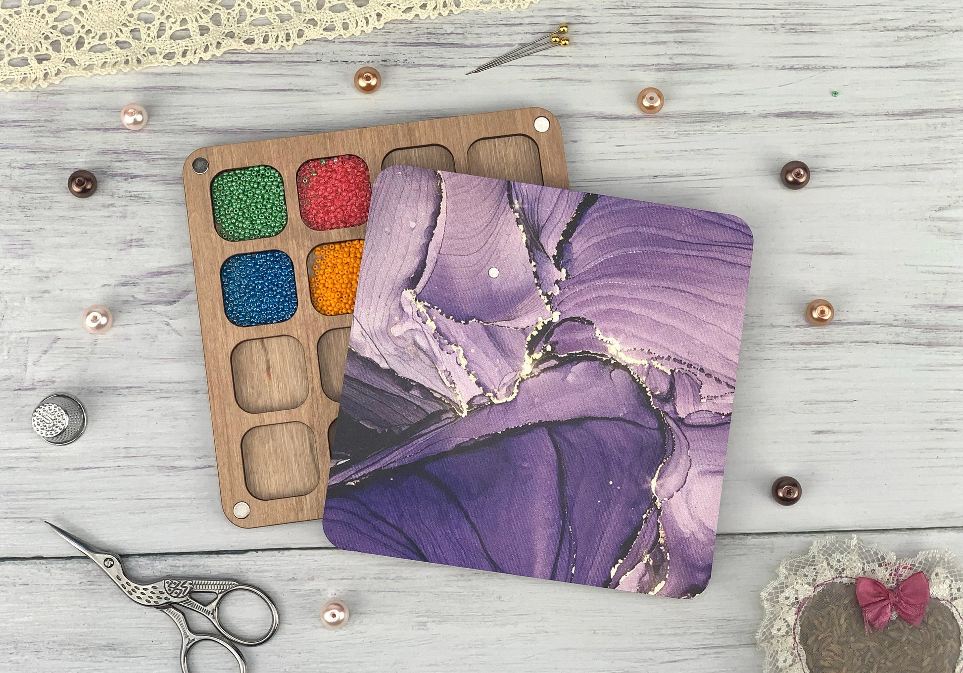 a pair of scissors and a painting palette on a table